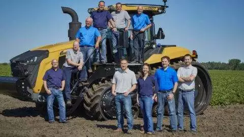 Wysocki Family of Companies family posed in front of tractor in field